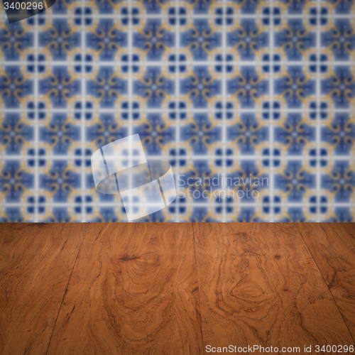 Image of Wood table top and blur vintage ceramic tile pattern wall