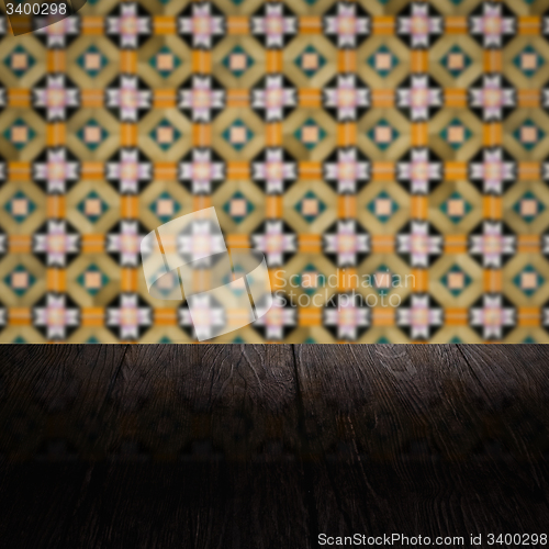 Image of Wood table top and blur vintage ceramic tile pattern wall