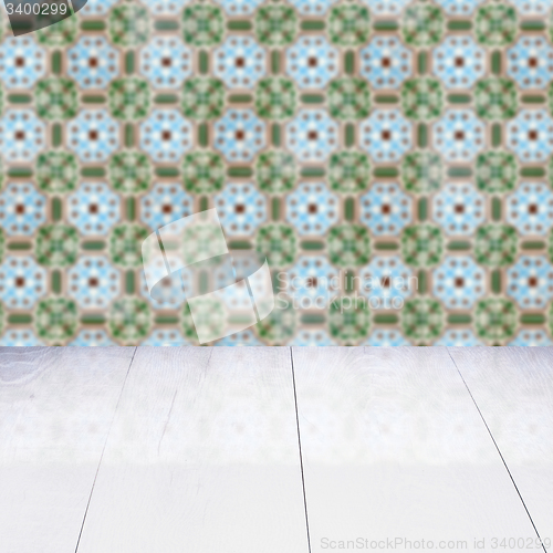 Image of Wood table top and blur vintage ceramic tile pattern wall