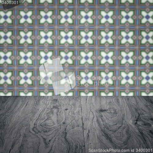 Image of Wood table top and blur vintage ceramic tile pattern wall