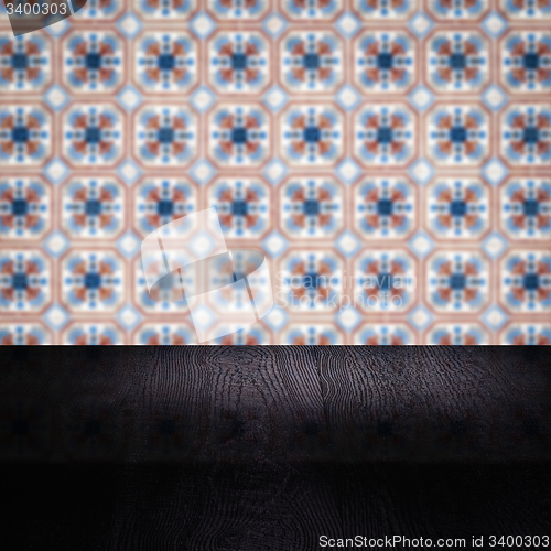 Image of Wood table top and blur vintage ceramic tile pattern wall