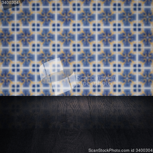 Image of Wood table top and blur vintage ceramic tile pattern wall