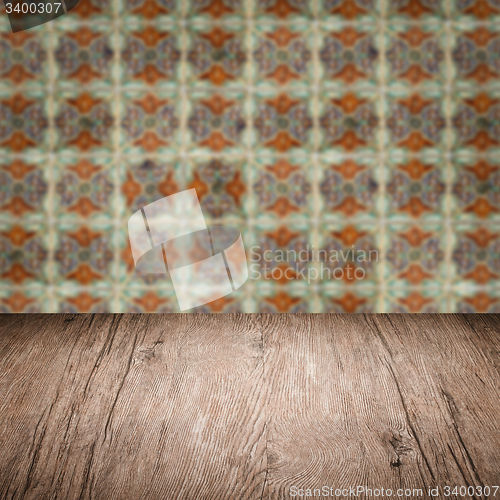 Image of Wood table top and blur vintage ceramic tile pattern wall