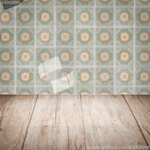 Image of Wood table top and blur vintage ceramic tile pattern wall