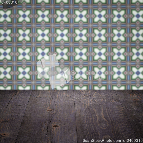 Image of Wood table top and blur vintage ceramic tile pattern wall