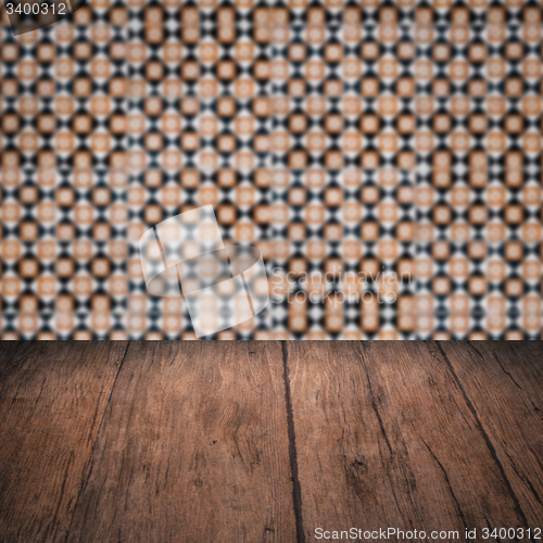 Image of Wood table top and blur vintage ceramic tile pattern wall