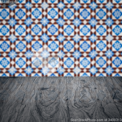 Image of Wood table top and blur vintage ceramic tile pattern wall