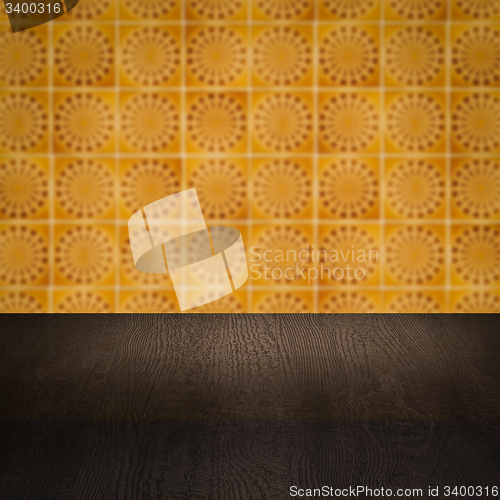 Image of Wood table top and blur vintage ceramic tile pattern wall