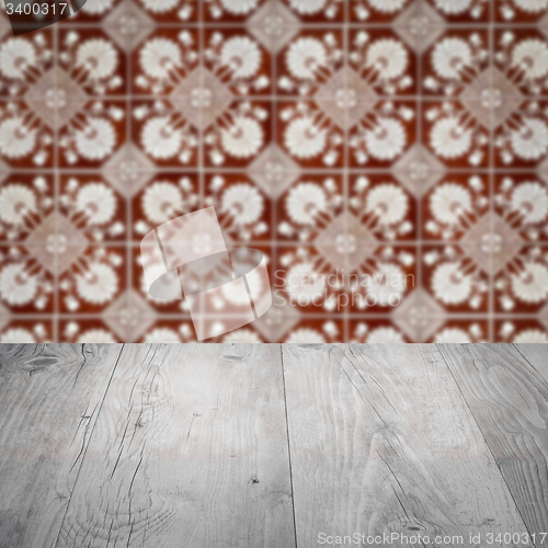Image of Wood table top and blur vintage ceramic tile pattern wall