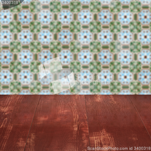Image of Wood table top and blur vintage ceramic tile pattern wall