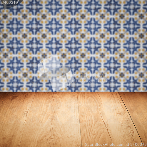 Image of Wood table top and blur vintage ceramic tile pattern wall
