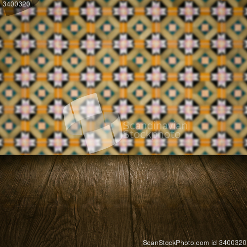Image of Wood table top and blur vintage ceramic tile pattern wall