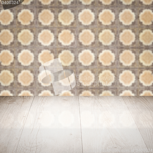 Image of Wood table top and blur vintage ceramic tile pattern wall
