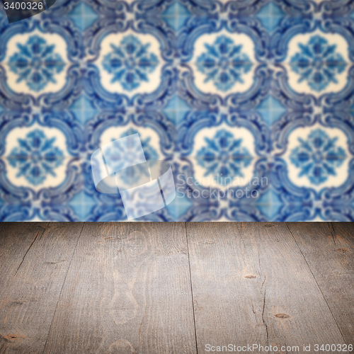 Image of Wood table top and blur vintage ceramic tile pattern wall