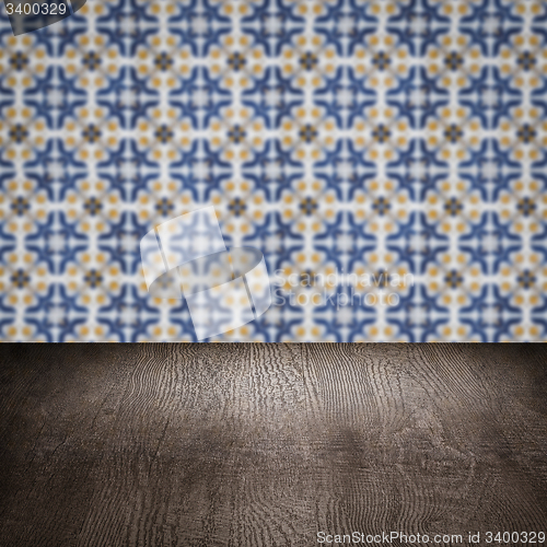 Image of Wood table top and blur vintage ceramic tile pattern wall