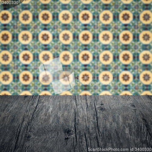 Image of Wood table top and blur vintage ceramic tile pattern wall