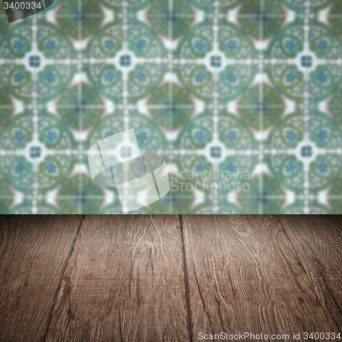Image of Wood table top and blur vintage ceramic tile pattern wall