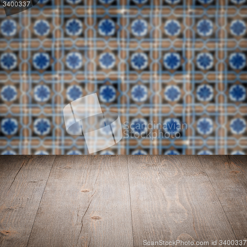 Image of Wood table top and blur vintage ceramic tile pattern wall