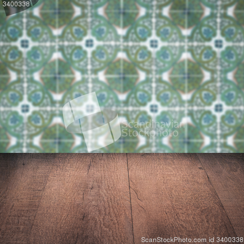 Image of Wood table top and blur vintage ceramic tile pattern wall