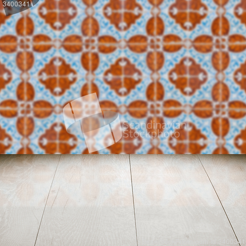 Image of Wood table top and blur vintage ceramic tile pattern wall