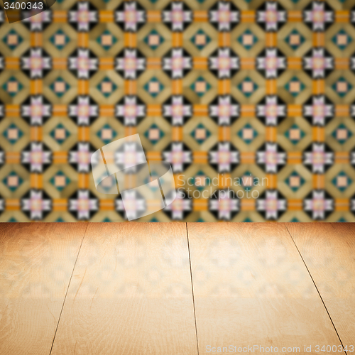 Image of Wood table top and blur vintage ceramic tile pattern wall
