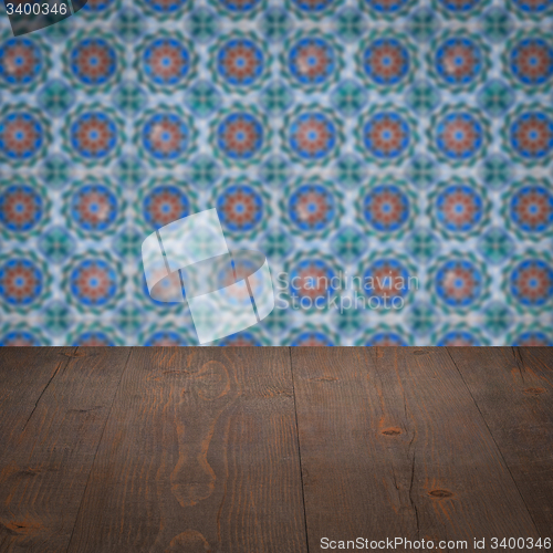 Image of Wood table top and blur vintage ceramic tile pattern wall