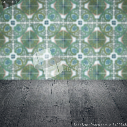 Image of Wood table top and blur vintage ceramic tile pattern wall