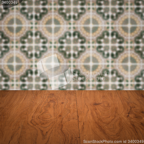 Image of Wood table top and blur vintage ceramic tile pattern wall