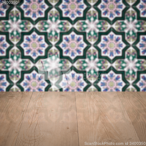 Image of Wood table top and blur vintage ceramic tile pattern wall
