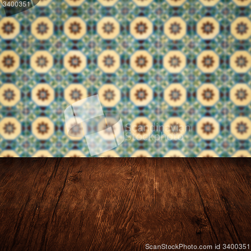 Image of Wood table top and blur vintage ceramic tile pattern wall