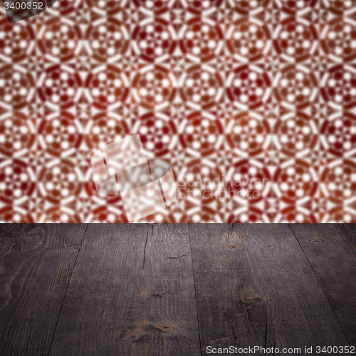 Image of Wood table top and blur vintage ceramic tile pattern wall