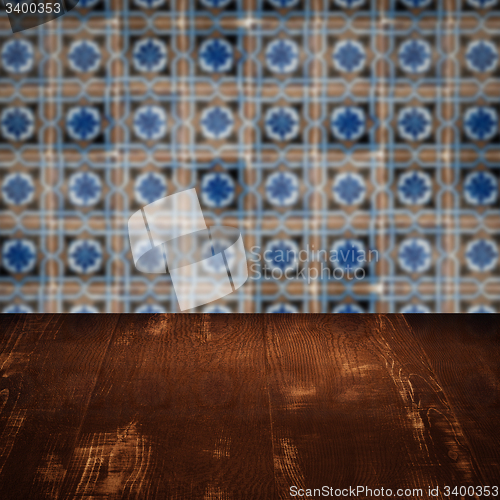 Image of Wood table top and blur vintage ceramic tile pattern wall