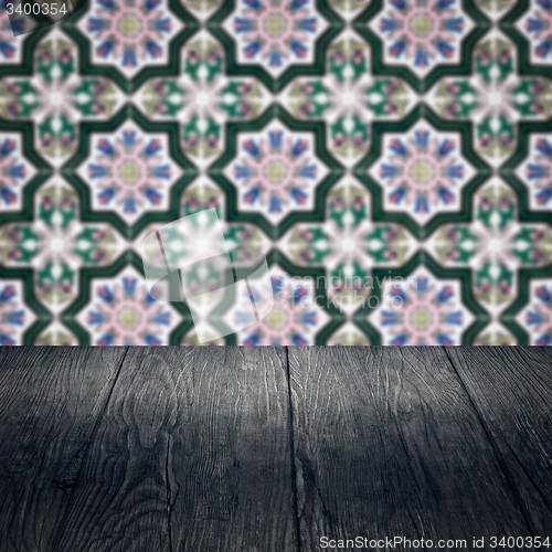Image of Wood table top and blur vintage ceramic tile pattern wall