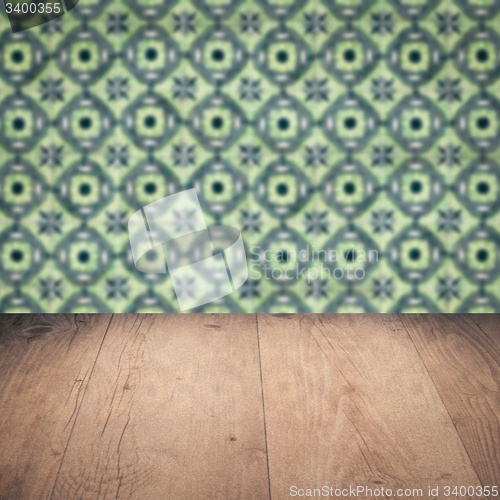 Image of Wood table top and blur vintage ceramic tile pattern wall