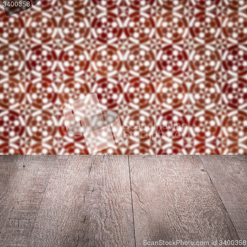 Image of Wood table top and blur vintage ceramic tile pattern wall