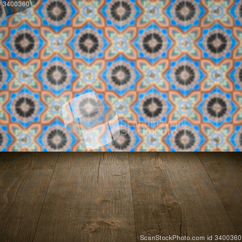 Image of Wood table top and blur vintage ceramic tile pattern wall