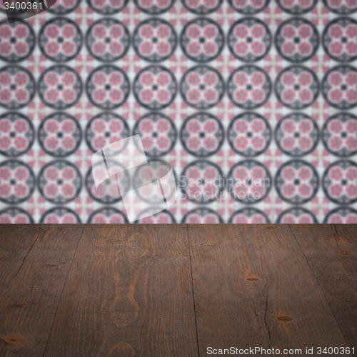 Image of Wood table top and blur vintage ceramic tile pattern wall