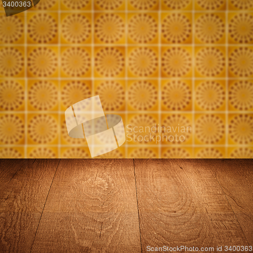 Image of Wood table top and blur vintage ceramic tile pattern wall