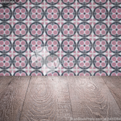 Image of Wood table top and blur vintage ceramic tile pattern wall