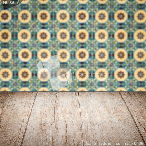 Image of Wood table top and blur vintage ceramic tile pattern wall
