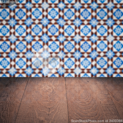 Image of Wood table top and blur vintage ceramic tile pattern wall
