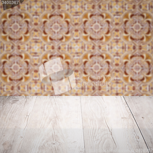 Image of Wood table top and blur vintage ceramic tile pattern wall