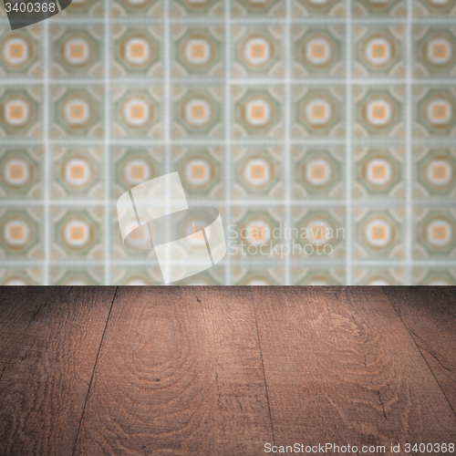 Image of Wood table top and blur vintage ceramic tile pattern wall