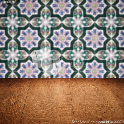Image of Wood table top and blur vintage ceramic tile pattern wall