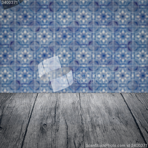 Image of Wood table top and blur vintage ceramic tile pattern wall
