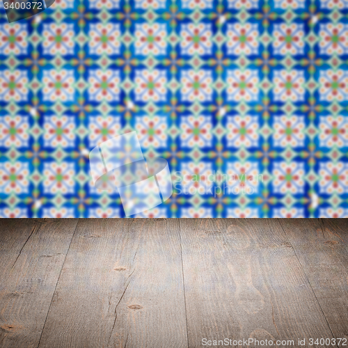 Image of Wood table top and blur vintage ceramic tile pattern wall
