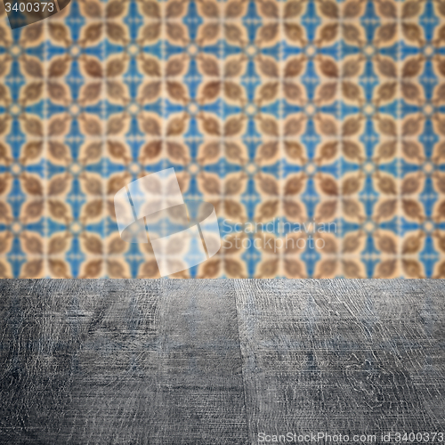 Image of Wood table top and blur vintage ceramic tile pattern wall
