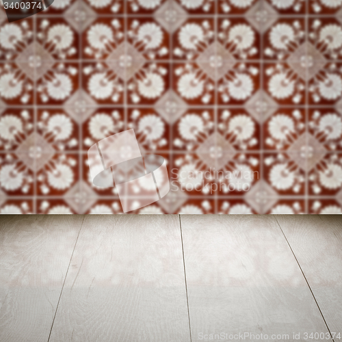 Image of Wood table top and blur vintage ceramic tile pattern wall