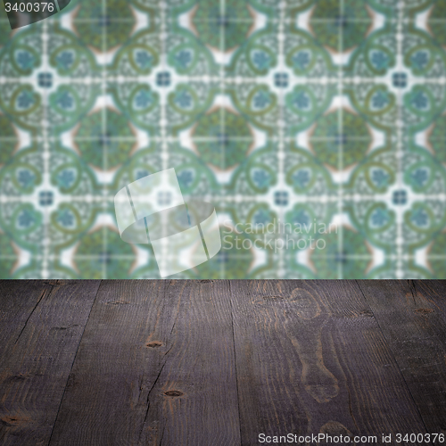 Image of Wood table top and blur vintage ceramic tile pattern wall