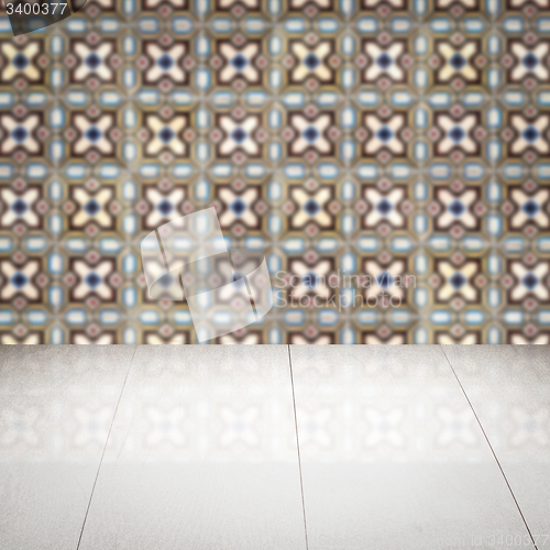 Image of Wood table top and blur vintage ceramic tile pattern wall